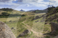 Path winds past hills and tourist ger camp towards distant mountains, Summer, Terelj National Park, Central Mongolia