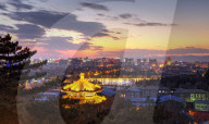 Illuminated pagoda and view towards the western part of Beijing city at nightfall.