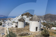 A typical greek village perched on a rock with its white and blue houses and quaint windmills Ios Cyclades Greece Europe