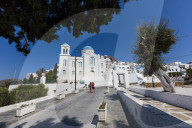 Tourists admire the architecture of Orthodox churches colored white and blu as symbols of Greece Ios Cyclades Europe