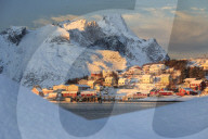 The last rays of sun on the fishing village and the snowy peaks, Kvalvika, Andoya, Reine, Nordland, Lofoten Islands, Arctic, Norway, Scandinavia, Europe
