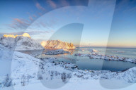 The colors of dawn frame the fishing villages surrounded by snowy peaks, Reine, Nordland, Lofoten Islands, Arctic, Norway, Scandinavia, Europe