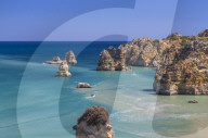 The turquoise water of the Atlantic Ocean and cliffs surrounding Praia Dona Ana beach, Lagos, Algarve, Portugal, Europe
