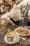 The typical milanese breakfast with Cappuccino and homemade Brioche at the old Cafe Cova icon of Milan Lombardy Italy Europe