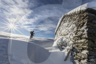 Snowshoe hiker walking near snow covered hut  Motta di Olano Gerola Valley Valtellina Orobie Alps Lombardy Italy Europe