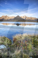 Peak TambÃ² and Peaks Piani are reflected in Lake Andossi at sunrise Spluga Valley Valtellina Lombardy Italy Europe