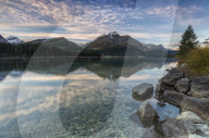 Pink sky at dawn illuminates the peaks reflected in Lake Sils Engadine Canton of GraubÃ¼nden Switzerland Europe