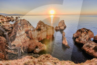 Golden sunrise on the red cliffs of Ponta Da Piedade Lagos Algarve Portugal Europe