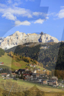 The colorful woods frame the village and the high peaks in autumn Gardena Valley South Tyrol Trentino Alto Adige Italy Europe