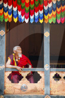 Monk watching the dancers at Paro festival