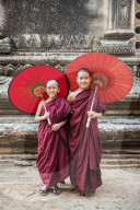 Two young monk and traditional umbrellas