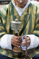 Local man holding a pray wheel and beeds