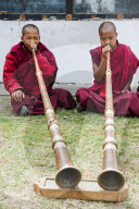 Monks playing Dungchen trumpet