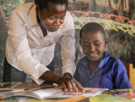 ISINGIZWE Alice 8 years old who is dumb and her teacher MUSABYEMARIYA Alphonsine from Ngwino Nawe, the village for children with disability, teaching Alice how to read a book using signs. Ngwino nawe works with VSO, an international non-governmental organ