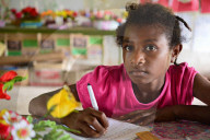 Young girl copying some work from the chalkboard at Kaindi demonstration school in Wewak, Papua New Guinea; captured by Sarah Wiles, VSO Multi-Media Producer.&nbsp; Sarah is from the UK and worked as a volunteer in PNG for the Language Support Program mak