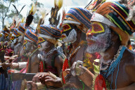 Highlands singsing performers at the Goroka show in Papua New Guinea. The nearest tribal dancer grasps his mobile phone showing the battle between tradition and modern culture in PNG.