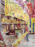 Supermarket worker selling promotions; consumerism in the new China