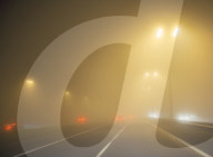 Motorway traffic in thick fog at night