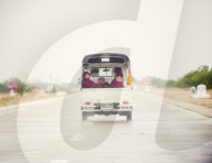 Buddhist monks travelling in the back of a pick up on a modern highway, Myanmar (Burma), Asia