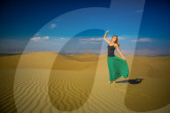 Woman standing on sand dune, Huacachina Oasis, Peru