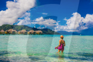 Woman wading in water, Le Taha'a Resort, Tahiti, French Polynesia