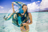 Woman standing in the water, Le Taha'a Resort, Tahiti, French Polynesia