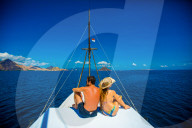 Couple relaxing on a Phinisi Boat, Flores Island, Indonesia