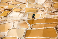 Woman mining Salt, Salineras de Maras, Maras Salt Flats, Sacred Valley, Peru