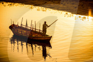 Silhouette of Indian Gondolier during the Flower Holi Festival, Vrindavan, India