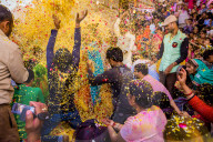Crowd throwing flower petals during the Flower Holi Festival, Vrindavan, India