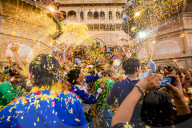 Crowd throwing flower petals during the Flower Holi Festival, Vrindavan, India