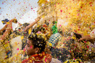 Crowd throwing flower petals during the Flower Holi Festival, Vrindavan, India