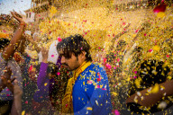 Crowd throwing flower petals during the Flower Holi Festival, Vrindavan, India