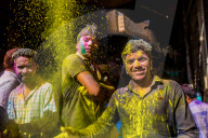 Men throwing yellow pigment, Holi Festival, Vrindavan, India