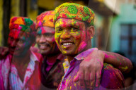 Men throwing colored pigment, Holi Festival, Vrindavan, India