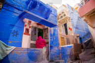 Woman standing infront of her blue house in Jodhpur, the Blue City, Rajasthan, India
