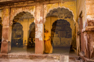 Woman hiding in the entranceway of Mehrangarh Fort in Jodhpur, the Blue City, Rajasthan, India