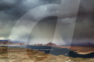 A storm obscures Grand Staircase-Escalante National Monument as it sweeps across Lake Powell and Wahweap Bay, Page, Arizona, USA