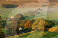 A thin veil of mist lies among the autumn coloured trees and dry stone walls in the Littondale valley, Yorkshire Dales, Yorkshire, England, United Kingdom, Europe