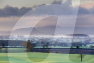 Low winter light rakes across the Cheshire plain with Beeston Castle and the Peckforton sandstone ridge beyond, Cheshire, England, United Kingdom, Europe