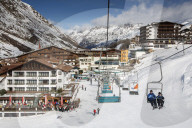 The alpine skiing village of Obergurgl with skiers relaxing while others head off on chairlifts to runs in the Otztal Alps, Tyrol, Austria, Europe