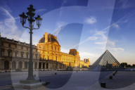Dawn light illuminates the Louvre Palace bordering the Napoleon Courtyard and Louvre Pyramid, Paris, France, Europe