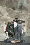 Children overload a local bus to get to school in Pakistan
