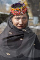 a Kalasha woman wearing traditional clothes in Pakistan