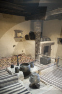 A ancient style kitchen with stone pots on display in a museum in the Hunza valley in Pakistan