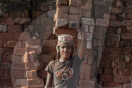 A young man carries up to 50 kilos of bricks by balancing them on his head, brick factory in Chittagong Hill Tracts, Bangladesh, Asia