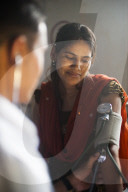 A doctor takes a woman's blood pressure in a hospital in Nepal, Asia