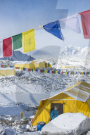 Prayer flags and the Everest base camp at the end of the Khumbu glacier that lies at 5350m, Himalayas, Nepal, Asia