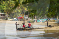 Fisherman organise their nets in Castara bay in Tobago