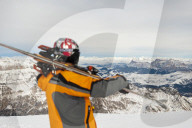 A skier prepares to ski down from the top of Marmolada in the Dolomites mountains in Italy